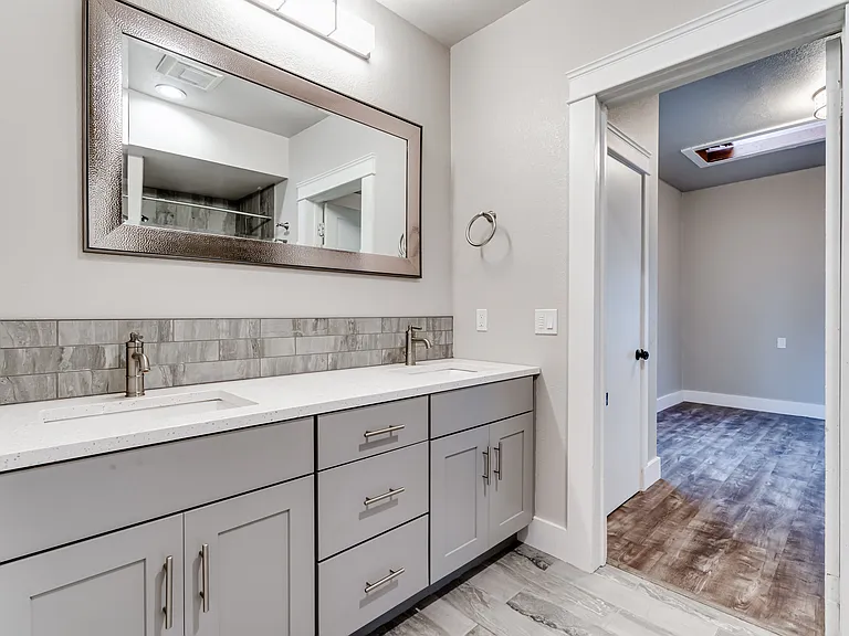 Two sinks with plenty of counterspace on the quartz countertop.