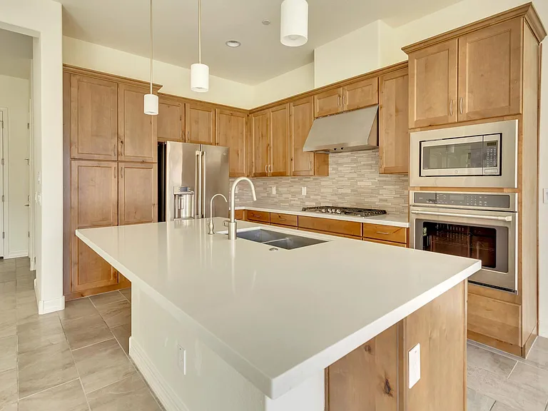 Quartz countertop along with GE gas appliances.