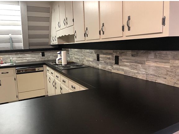 Kitchen counter with backsplash and cabinets