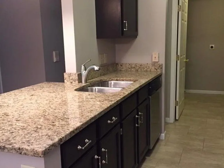 Kitchen with a newer faucet and garbage disposal
