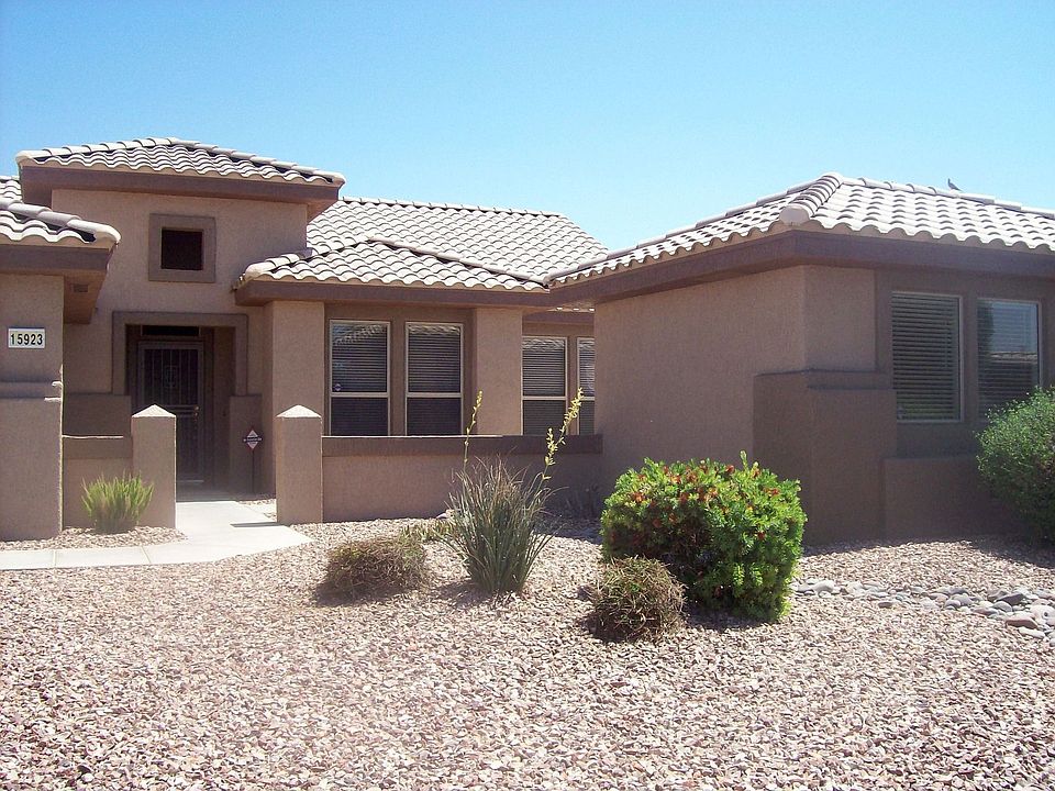 Stucco and tiled roof with desert landscaping