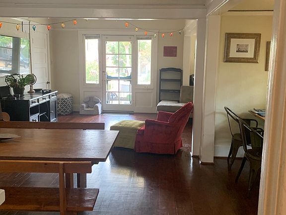 view from kitchen of dining room and living room to front door