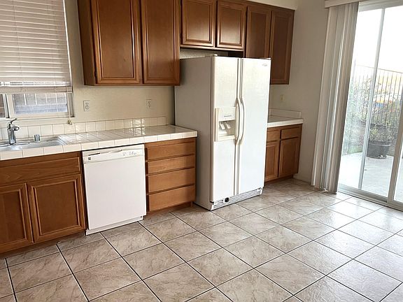 Spacious kitchen with refrigerator included. Kitchen nook opens up to the back yard.