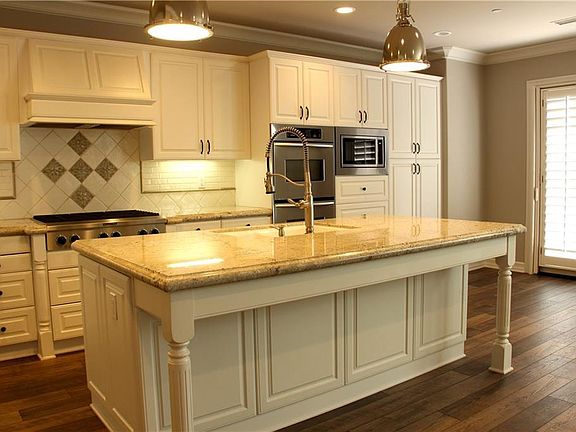 Another view of the kitchen with door to back yard