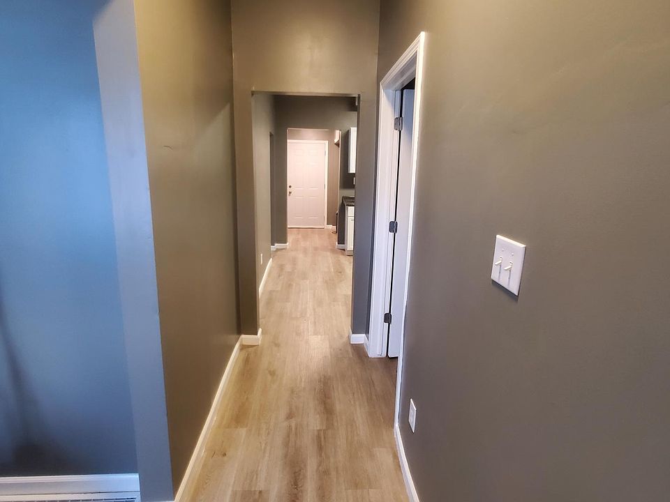 Front door (from private porch) looking down hall, living room on left, bedroom 2 on right)