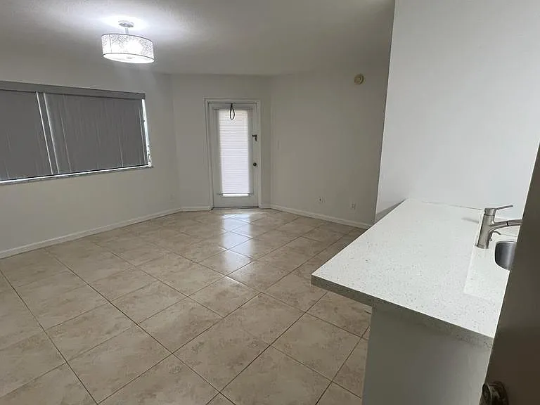 Open living room area, next to kitchen. Living room has blinds that can be closed for privacy. Living room is nicely laid out. Natural tree shading adds to privacy. 
 Rented unfurnished.