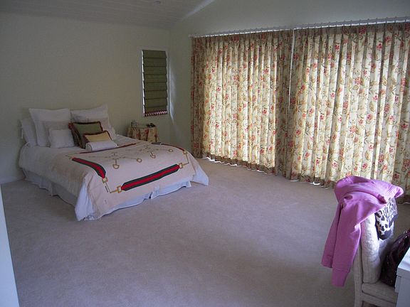 bedroom with vaulted ceiling and deck