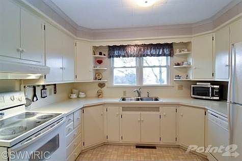 Efficient kitchen with view to back gardens.