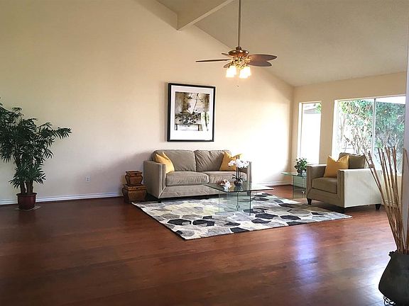 Large living room with vaulted ceiling and entire rear open to the private garden.