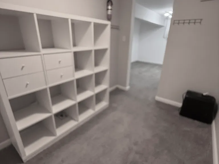 Huge walk-in closet with built-in storage.