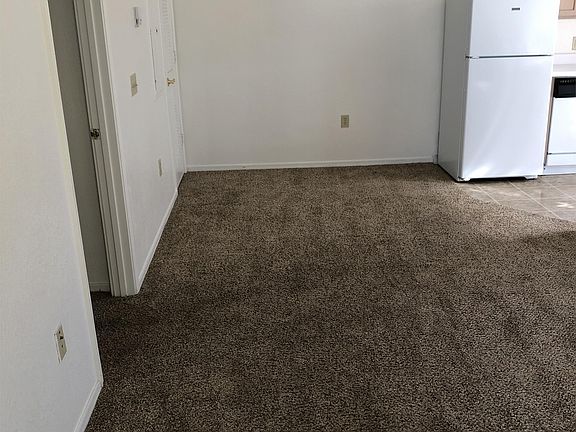 Dining room with the ceiling fan going into the kitchen area