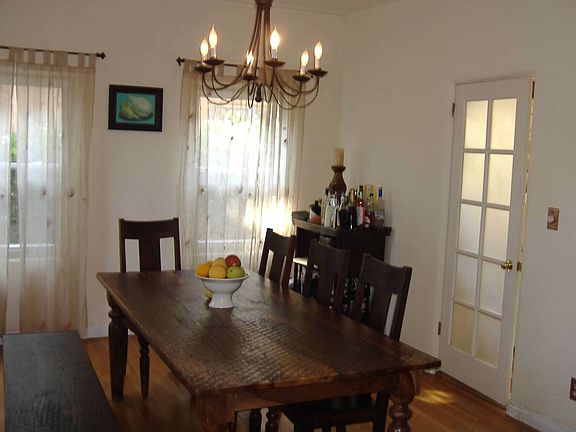 Large private dining room with arched entry and door to kitchen