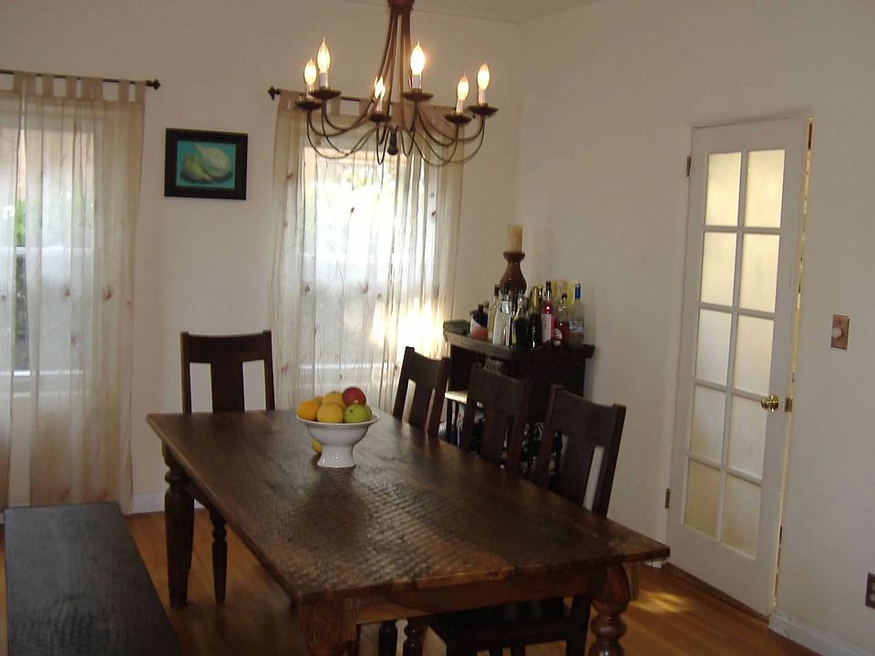 Large private dining room with arched entry and door to kitchen