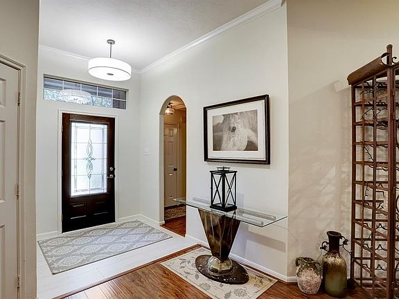 Enter the home through the beautiful glass front door. Entry features designer light fixtures, tile and wood floors! This home has tons of natural light, and a wonderful floor plan.