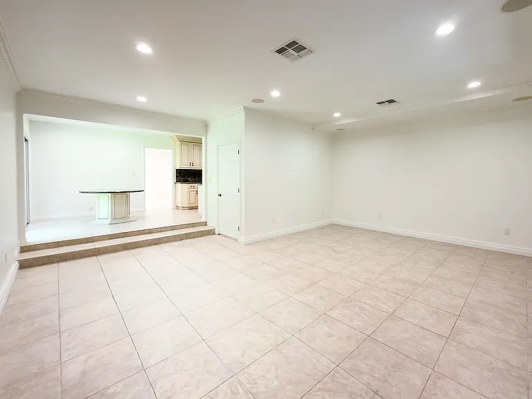 Open family room with tile flooring flows into the kitchen, offering versatile living space in this Beverly Hills luxury rental at 1094 Garden Lane, a 90210 home for rent.