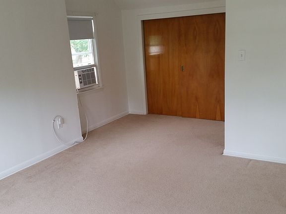 Bedroom with shelving storage in double wide closet