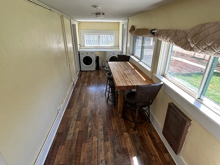 Laundry day just got an upgrade! Fold clothes in this quirky hallway while soaking in views of the backyard and mountains. Who knew chores could come with such scenic motivation? Awkward hallway, meet your new purpose.