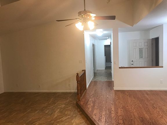 Oak hardwood floor entry, brass LED ceiling fan.