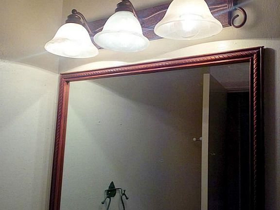 Trendy light fixture in hall bath