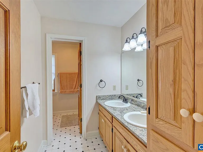 The kids bathroom has two vanities and a separate toilet/shower room. The vanity is granite.