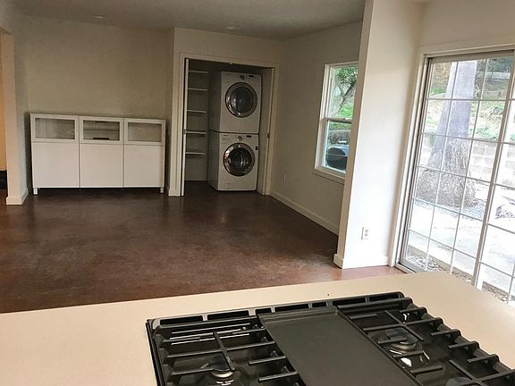 Dining room with china cabinet and laundry.