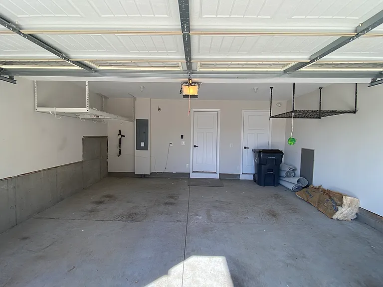Garage includes overhead storage racks and closet