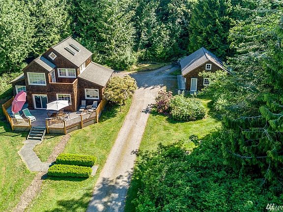 Home's placement takes advantage of light, detached garage/shop to the right.