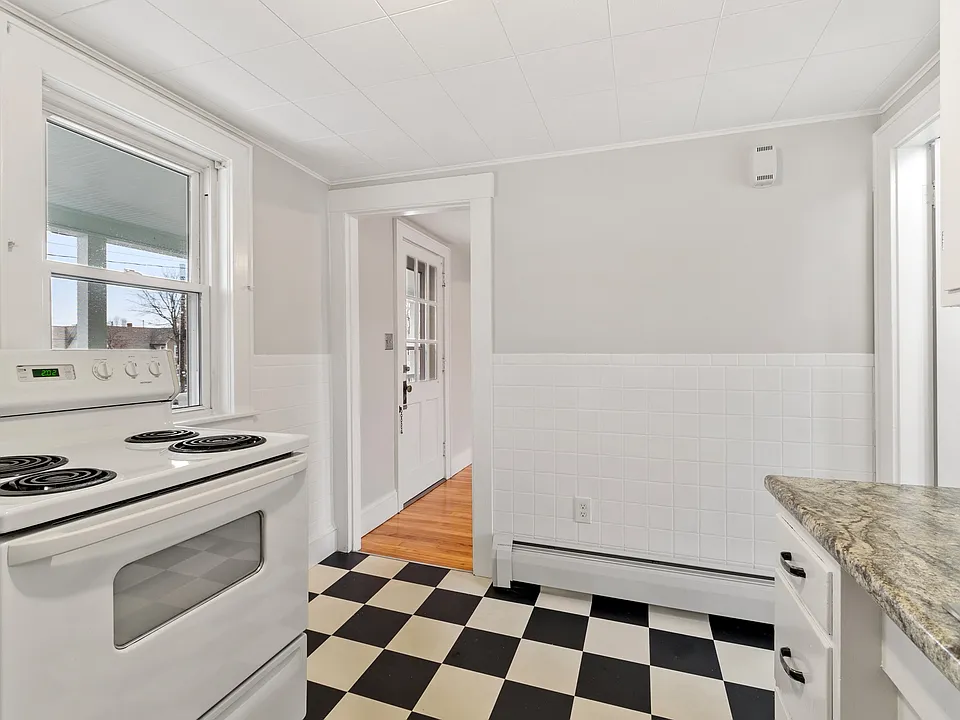 Kitchen with door to dining room and bathroom to the right.