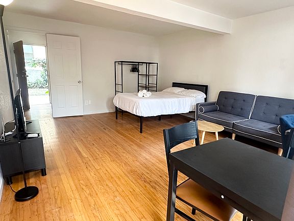 Bedroom w patio access. Pictured as currently furnished