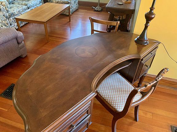 A classic desk overlooking living room.