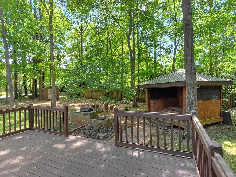 Back of the house and gazebo. There is a hot tub, not available for use in the gazebo. (It doesn't work.). There is a cover on it.