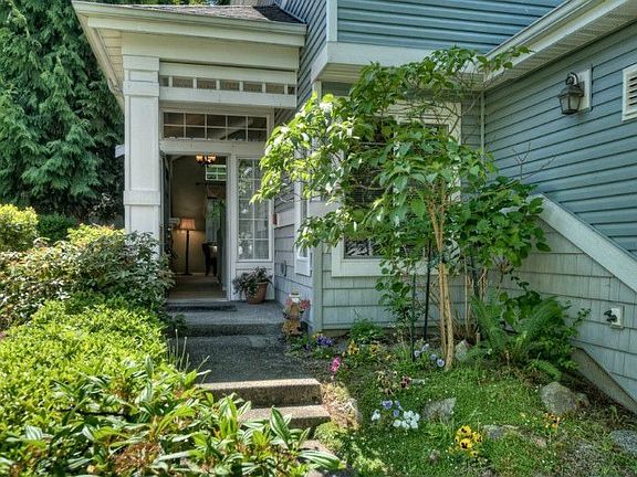 Enter this immaculate home through well-maintained landscaping and private path, or through the atta