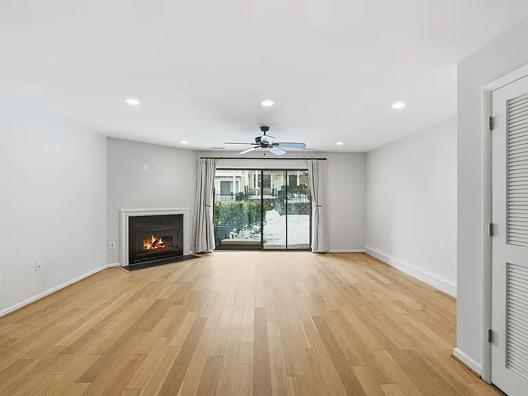 living area with fireplace and patio view