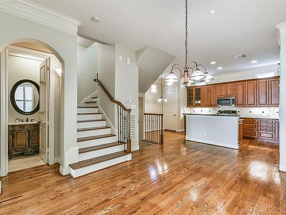 Spacious dining area with gorgeous hardwoods open to the kitchen.