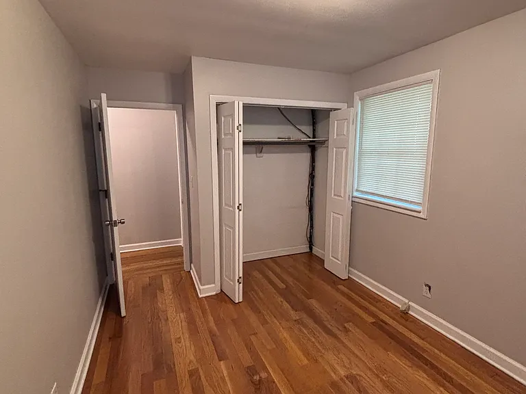 Back bedroom with ample closet space and two windows.