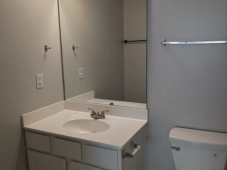 Private en-suite full bathroom with vanity storage and tile flooring
