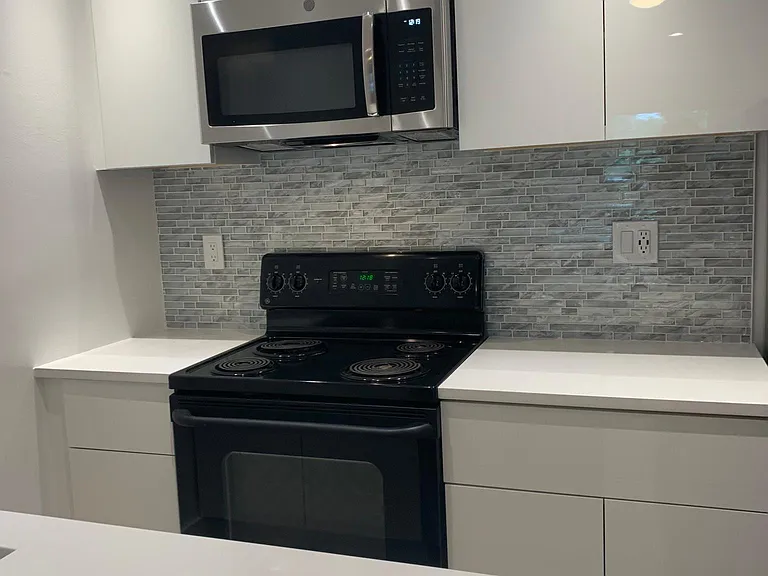 Kitchen- Excuse the top cabinet. It will be replaced w/ matching cabinets