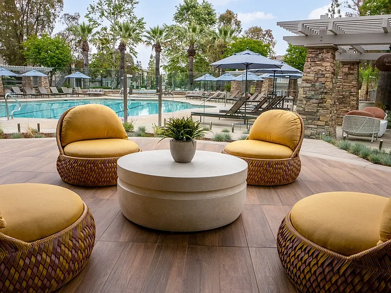 Poolside Patio with Woven Lounge Chairs and Round Coffee Table
