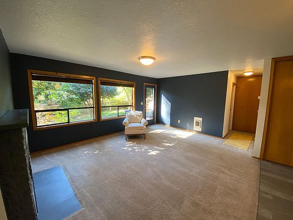 Livingroom with door leading to back yard. Faux brick fireplace. Short hallway leaded to master bedroom on left and bathroom on right.