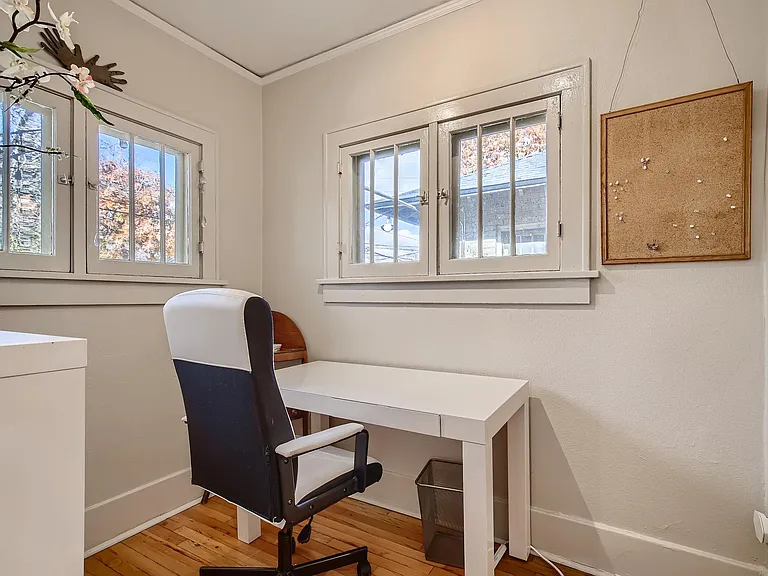 Private office space with plenty of sunlight and bookshelf storage.