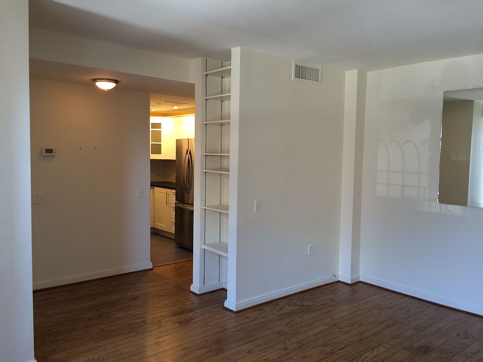 Main living room shelving and wall mounted mirror to reflect light.