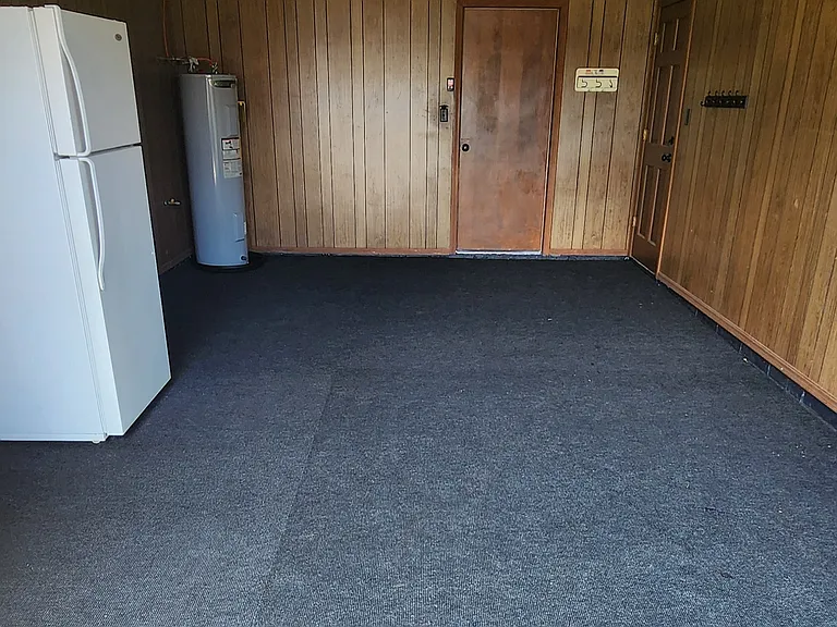 Finished garage with spare fridge.