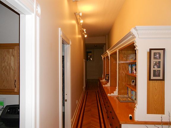 Hallway that accesses two of the bedrooms and laundry room. Lots and lots of storage in the built in wall cabinet.