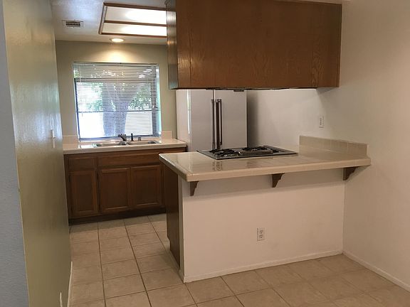 Now has newer stainless steel side by side refrigerator. Features a garden window by the kitchen sink.