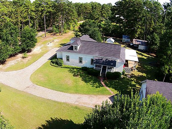 Side entrance to home with lovely original front porch and new driveway