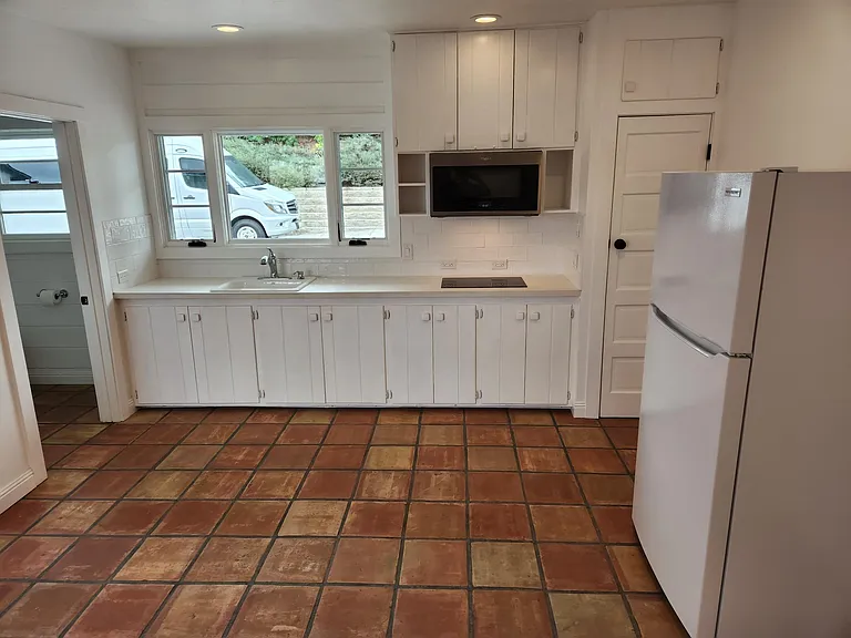 Kitchen space provides lots of room to prepare along with storage.
