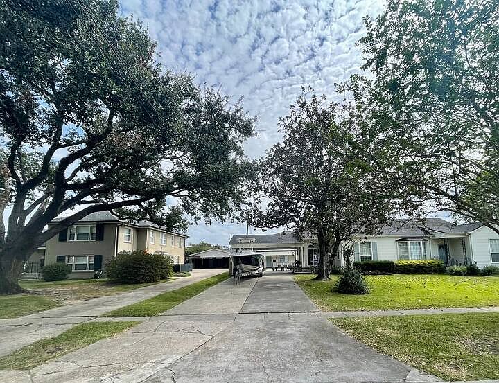 Apartment building is behind my house.
