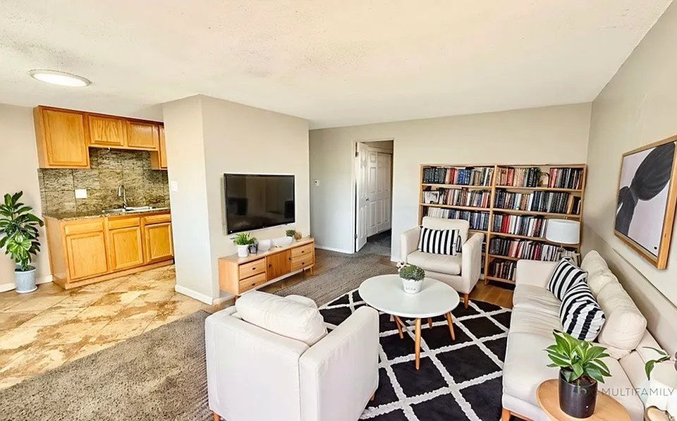 Inviting living room with cozy seating, stylish decor, and integrated kitchen area, perfect for relaxation and social gatherings.