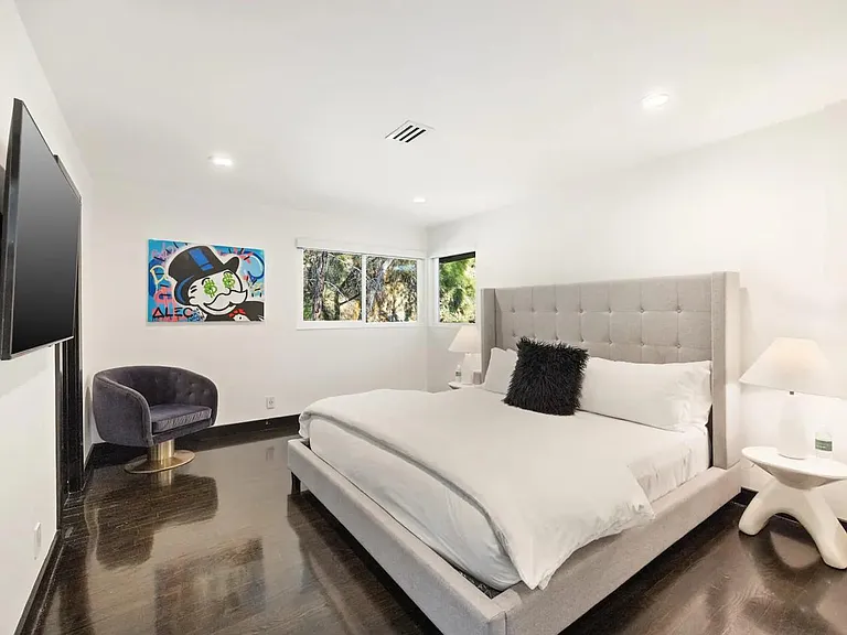 Discover relaxation in our serene bedroom retreat, complete with a plush king-size bed and blackout shades.