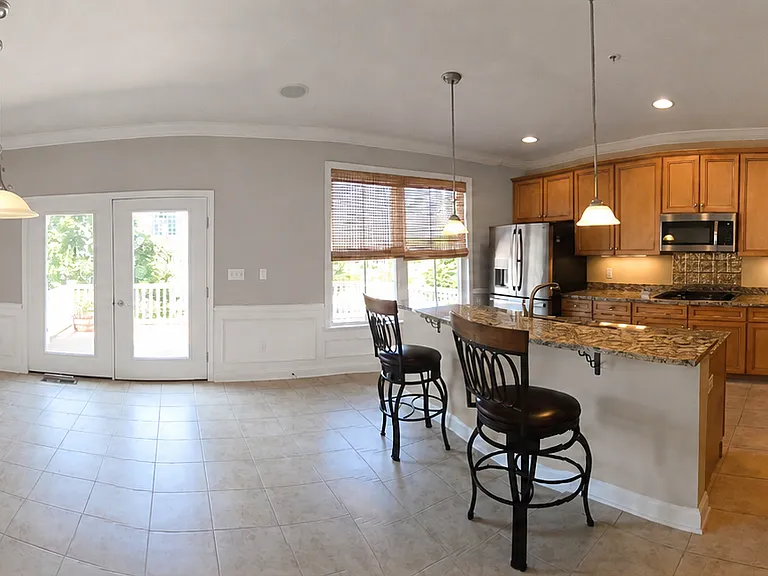 Second floor - kitchen, dining room and entrance to spacious outdoor deck.